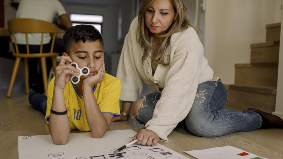 Mum helping son with homework