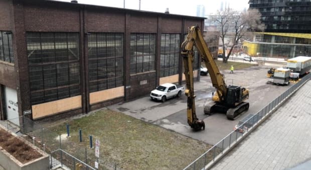 Community members have been fighting to stop the province from demolishing four industrial heritage buildings on the site. One building is already damaged by a demolition crew. 