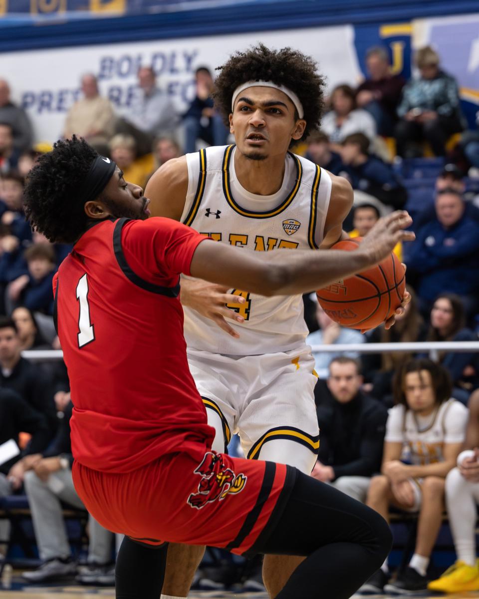 Kent State forward Chris Payton Jr. drives through Ball State guard Jalin Anderson to the basket Jan. 3 in Kent.