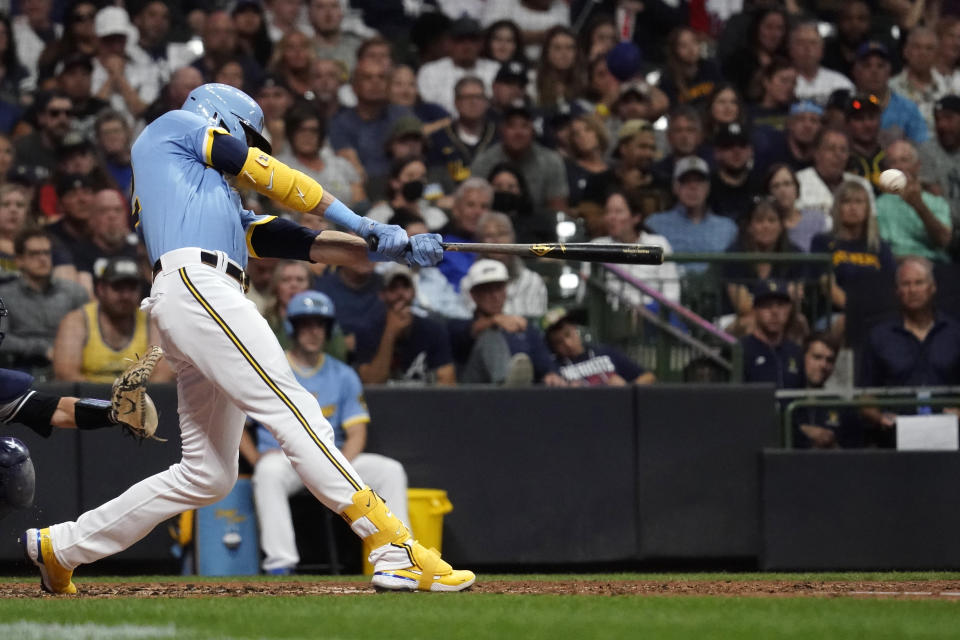 Milwaukee Brewers' Christian Yelich hits an RBI triple during the fifth inning of a baseball game against the New York Yankees Saturday, Sept. 17, 2022, in Milwaukee. (AP Photo/Aaron Gash)