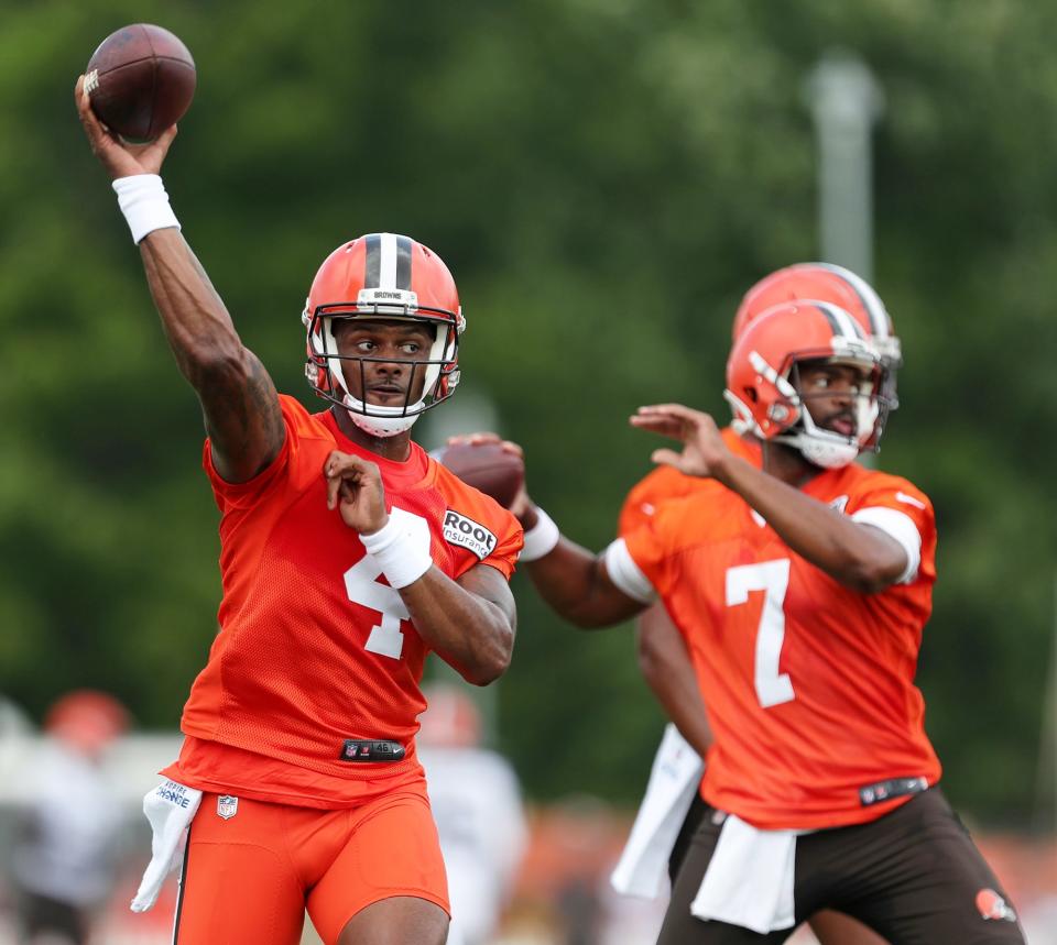 Cleveland Browns quarterback Deshaun Watson, left, throws with Jacoby Brissett during the NFL football team's football training camp in Berea on Monday.
