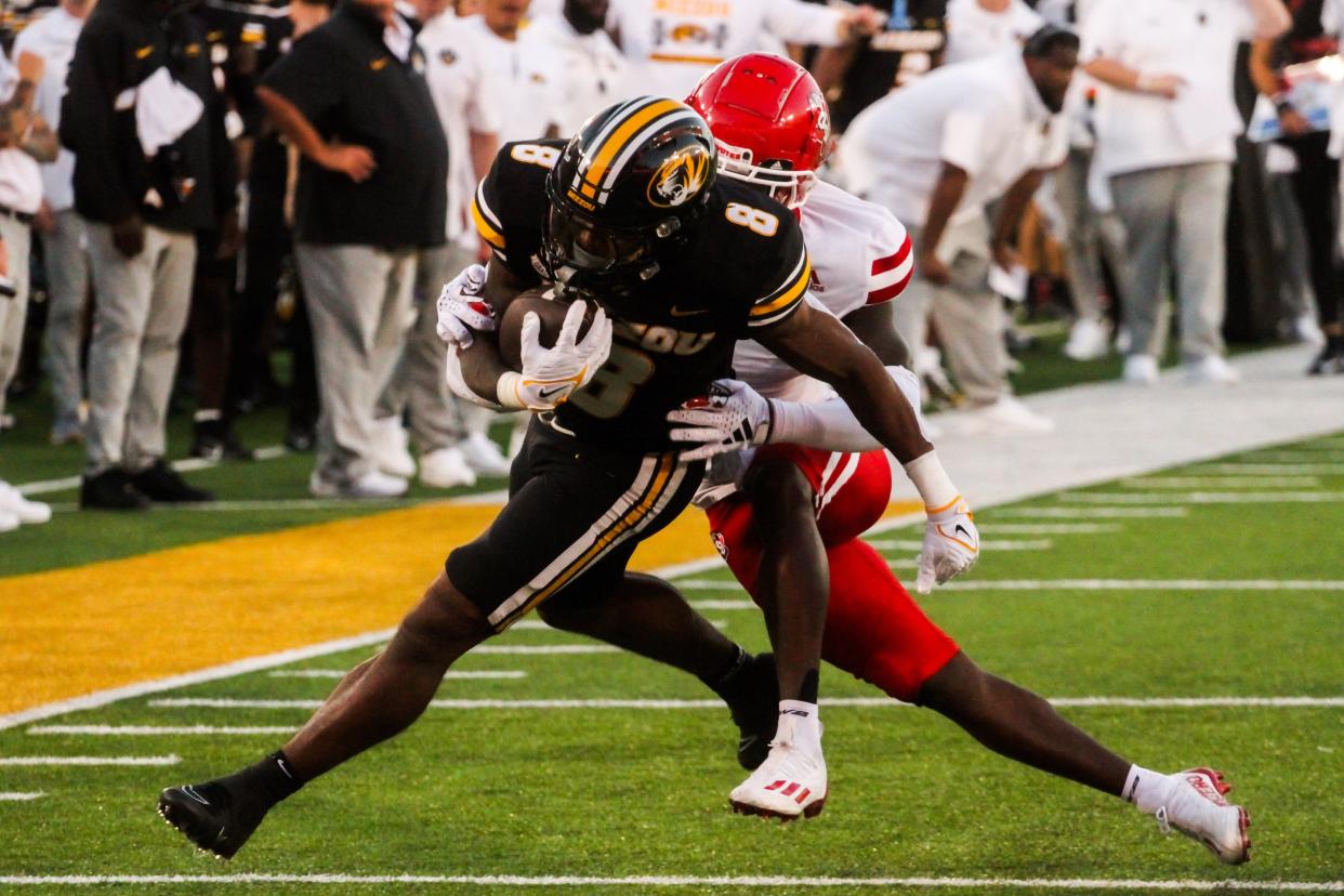 Missouri running back Nathaniel Peat tries to shred a South Dakota defender during a game against the Coyotes at Memorial Stadium on August 31, 2023, in Columbia, Mo.