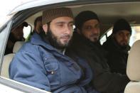 Members of the Lebanese security forces who were kidnapped by jihadist groups from Arsal near the Syrian border last year sit in a Red Cross vehicle moments after their release on December 1, 2015