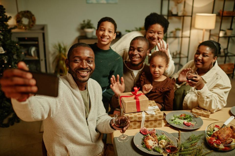 high angle portrait of happy african american family taking selfie photo while enjoying christmas at home together