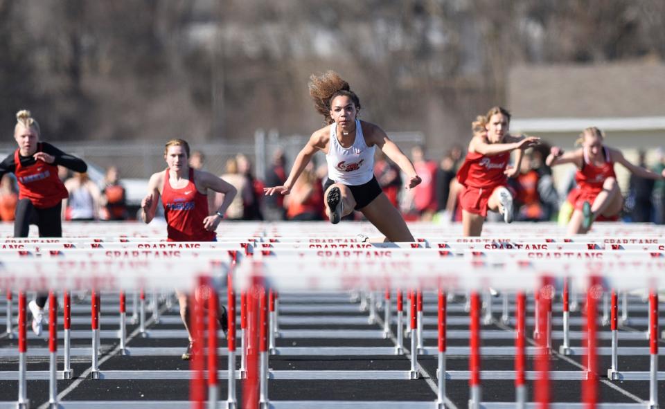 ROCORI junior Cecelia Woods clears a hurdle Thursday, April 21, 2022, at the Ed Babcock Invitational in Cold Spring.