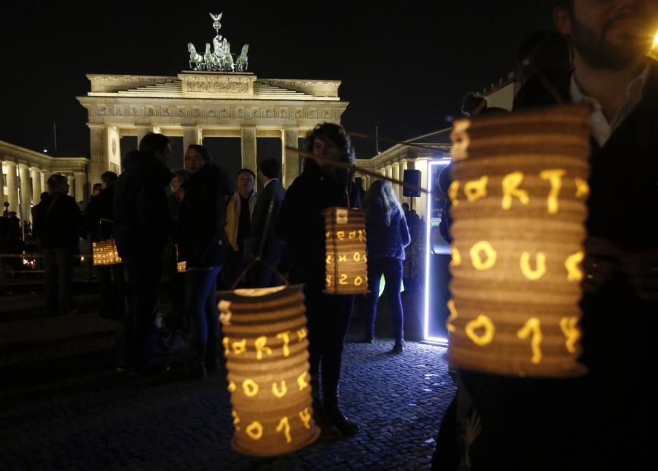 People gather in front of the Brandenburger Tor gate before Earth Hour in Berlin