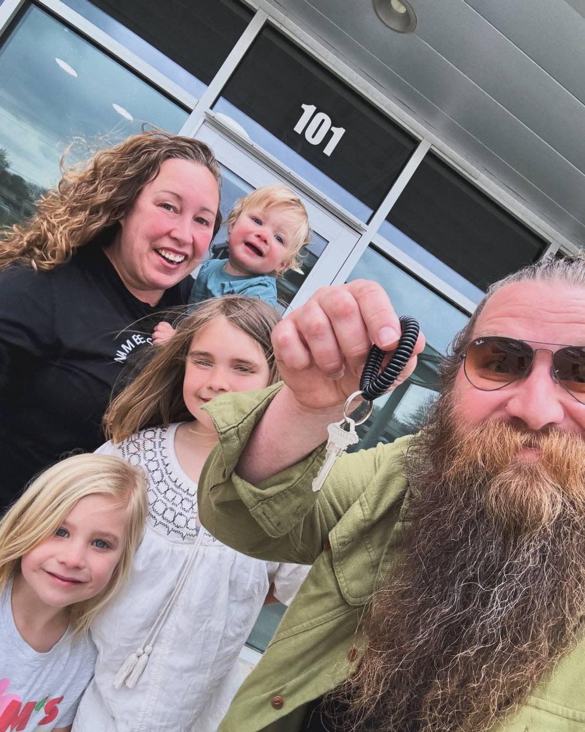 Clay Hoberecht flashes the keys to his family’s new Wichita Wagyu shop at Tyler Pointe. Pictured with him are his wife, Barb, son, Chandler (in his mother’s arms) and daughters Chase, left, and Charlie, center. Courtesy photo