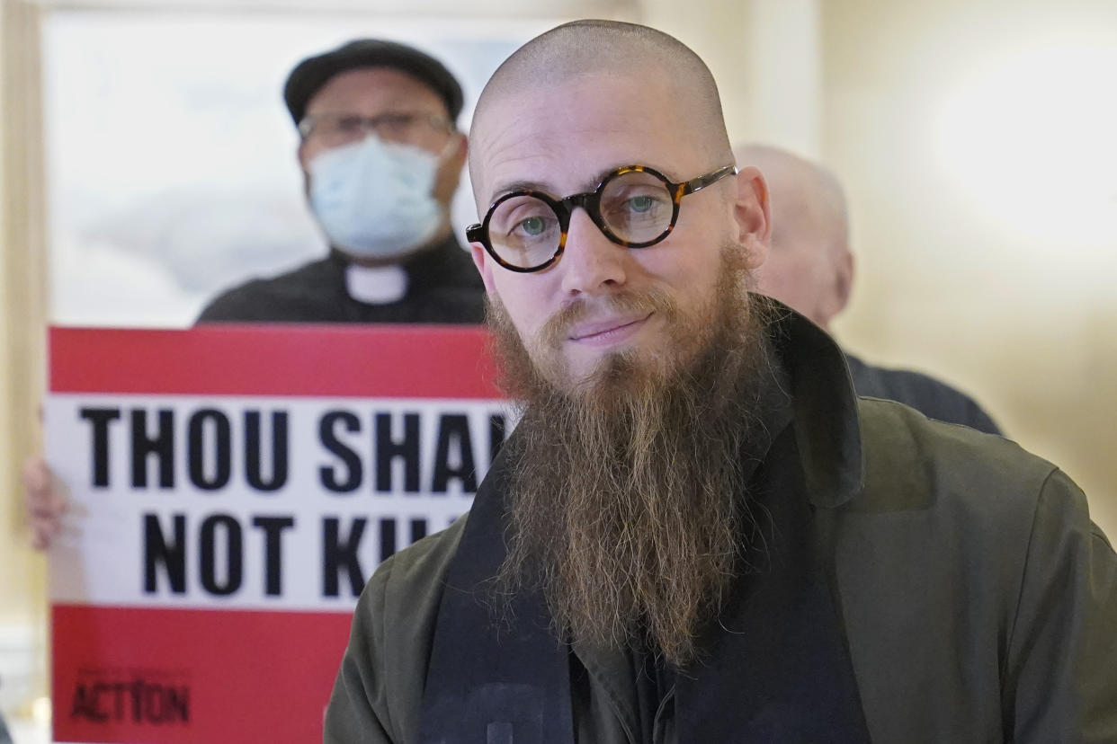 The Rev. Jeffrey Hood, of Arkansas, speaks to the media before protestors deliver petitions against the death penalty to the office of Oklahoma Gov. Kevin Stitt, Wednesday, Jan. 11, 2023, in Oklahoma City. The Oklahoma Department of Corrections has reversed its position and now says it will allow Hood, an anti-death penalty minister, inside the execution chamber for the upcoming execution of Scott Eizember. Eizember was convicted of killing A.J. Cantrell, 76, and his wife, Patsy Cantrell, 70, in 2003. (AP Photo/Sue Ogrocki)