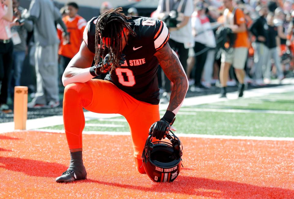 Oklahoma State's Ollie Gordon II (0) kneels in the end zone before a Bedlam college football game between the Oklahoma State University Cowboys (OSU) and the University of Oklahoma Sooners (OU) at Boone Pickens Stadium in Stillwater, Okla., Saturday, Nov. 4, 2023.