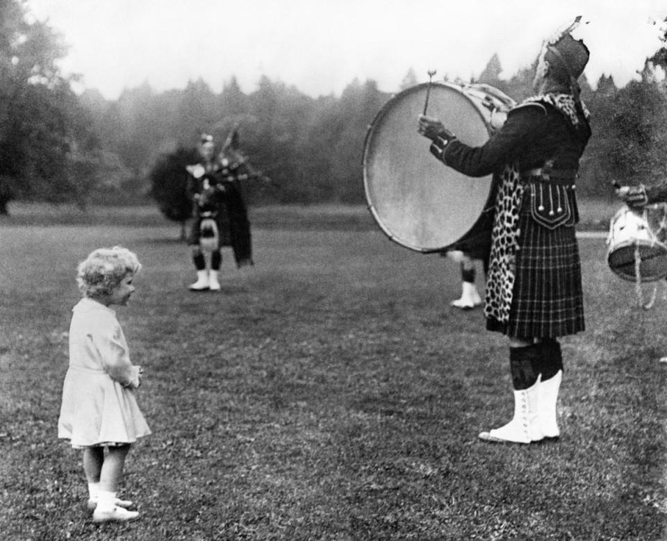 Princess Elizabeth and a Highland Regiment drummer, during a visit to Scotland in 1930 (PA )