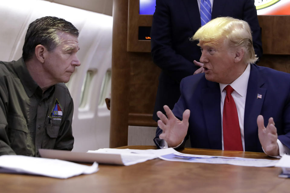 President Donald Trump participates in a briefing with North Carolina Gov. Roy Cooper about Hurricane Dorian at Marine Corps Air Station Cherry Point, Monday, Sept. 9, 2019, in Havelock, N.C., aboard Air Force One. (AP Photo/Evan Vucci)