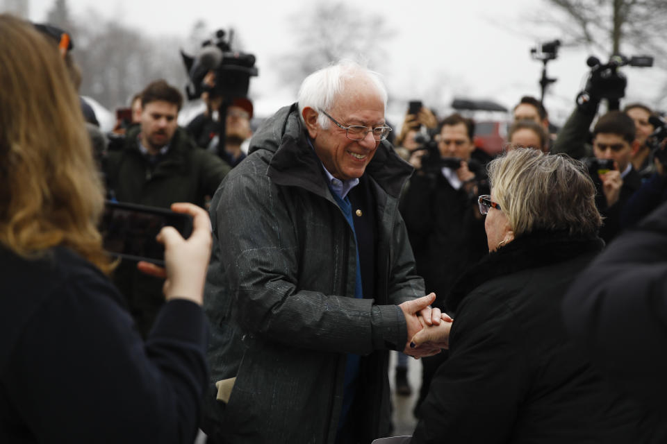 Democratic presidential candidate Sen. Bernie Sanders, I-Vt., meets with people outside a polling place where voters will cast their ballots in a primary election, in Manchester, N.H., Tuesday, Feb. 11, 2020. (AP Photo/Matt Rourke)