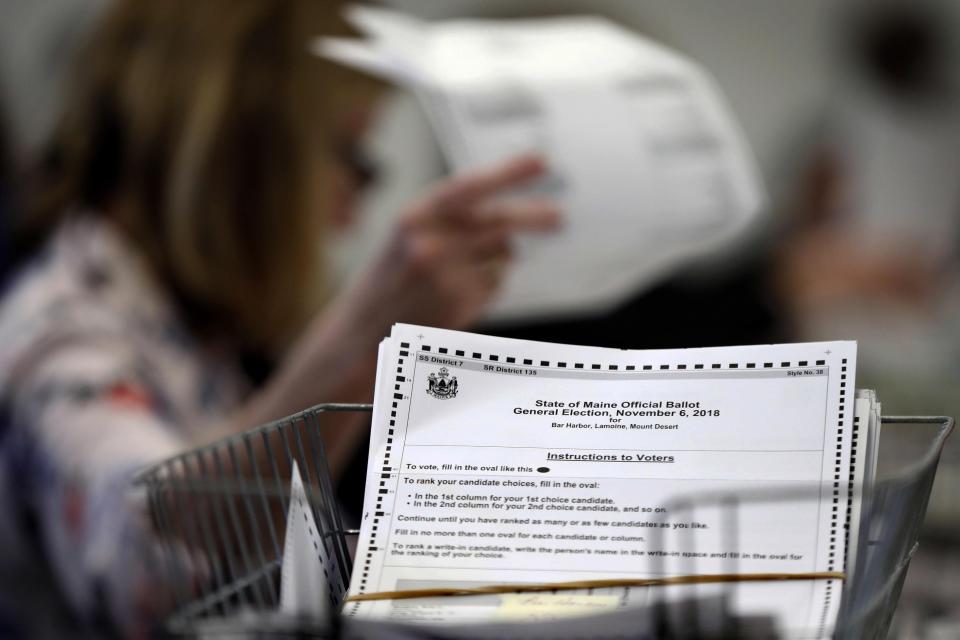 In this Dec. 6, 2018, file photo, ballots are recounted in Maine's 2nd Congressional District in Augusta, Maine. In 2020, general election, Maine Secretary of State Matthew Dunlap launched a new online service that allows voters to track the status of their absentee ballot.
(Credit: AP Photo/Robert F. Bukaty, file)