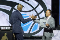 RETRANSMISSION TO CORRECT ID TO JAMAHL MOSLEY - Orlando Magic head coach Jamahl Mosley, left, is congratulated by NBA Deputy Commissioner Mark Tatum after Tatum announced that the Magic have won the first pick in the 2022 NBA draft during the NBA basketball draft lottery Tuesday, May 17, 2022, in Chicago. (AP Photo/Charles Rex Arbogast)