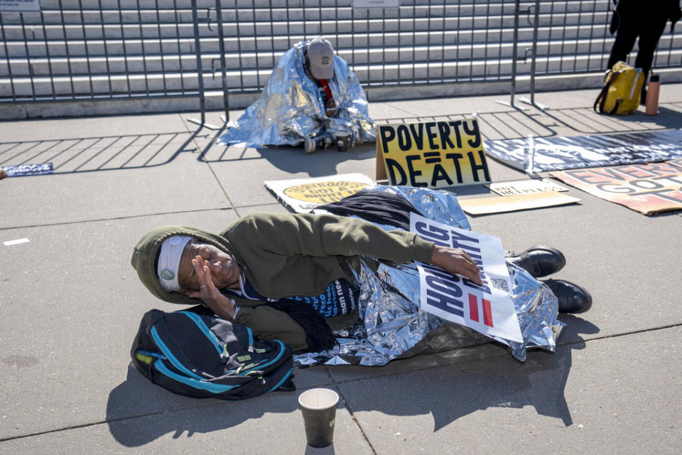 Activists demonstrate at the Supreme Court as the justices consider a challenge to rulings that found punishing people for sleeping outside when shelter space is lacking amounts to unconstitutional cruel and unusual punishment, on Capitol Hill in Washington, Monday, April 22, 2024. (AP Photo/J. Scott Applewhite)