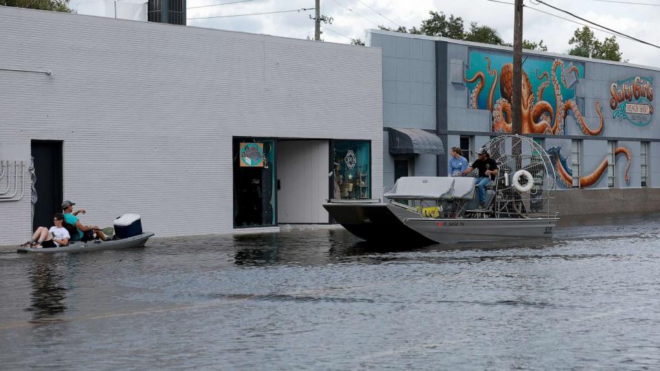 PHOTO: Kayakers and an airboat cruise down a flooded street after Hurricane Idalia passed offshore on Aug. 30, 2023, in Crystal River, Fla. Hurricane Idalia hit the Big Bend area on the Gulf Coast of Florida as a Category 3 storm. (Joe Raedle/Getty Images)