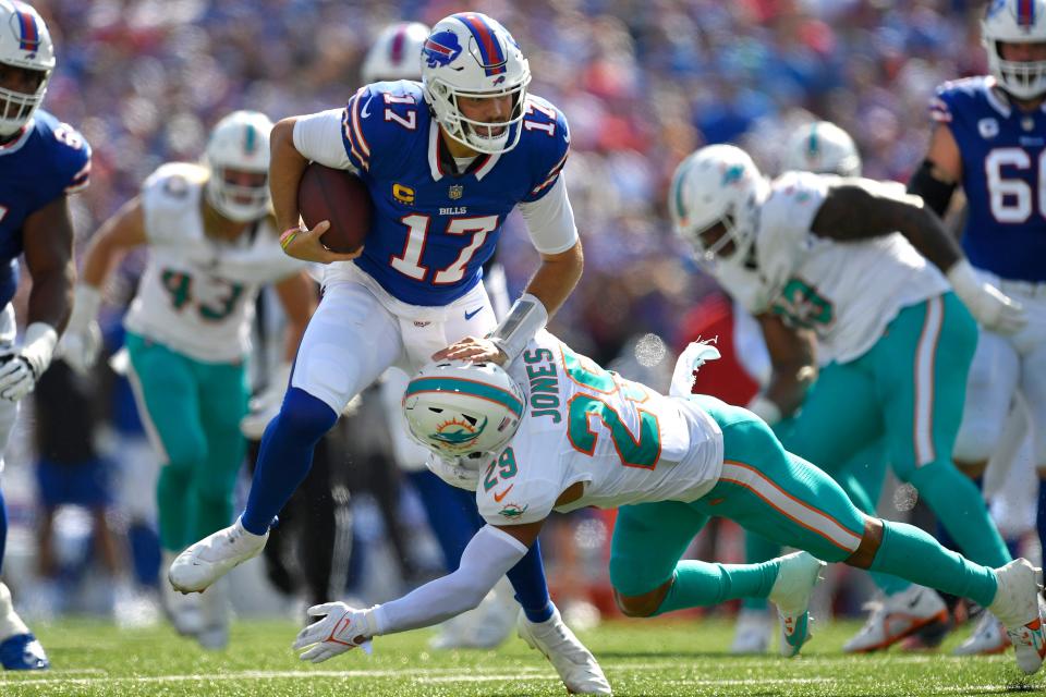 Buffalo Bills quarterback Josh Allen (17) is brought down by Miami Dolphins safety Brandon Jones (29) during the first half an NFL football game, Sunday, Oct. 1, 2023, in Orchard Park, N.Y. (AP Photo/Adrian Kraus)