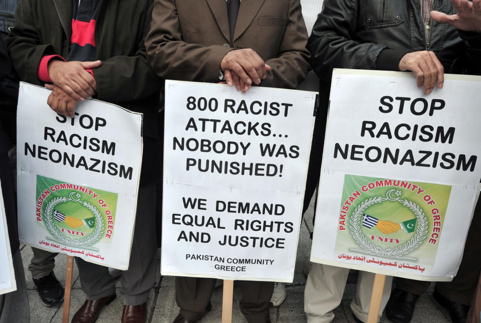 Immigrants hold placards in Athens on December 15, 2012 during a European march for democracy against racism, antisemitism and neo-Nazism. (LOUISA GOULIAMAKI/AFP/Getty Images)