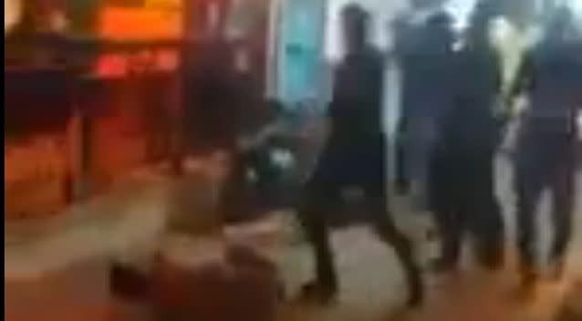 A man is kicked as he lays on the floor. Photo: LiveLeak