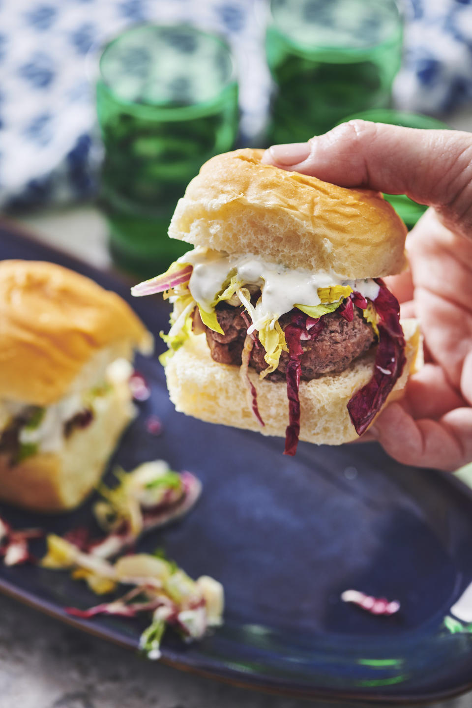 This April 2019 image shows a recipe for chipotle sliders with a colorful lettuce slaw and blue cheese dressing in New York. (Cheyenne Cohen via AP)