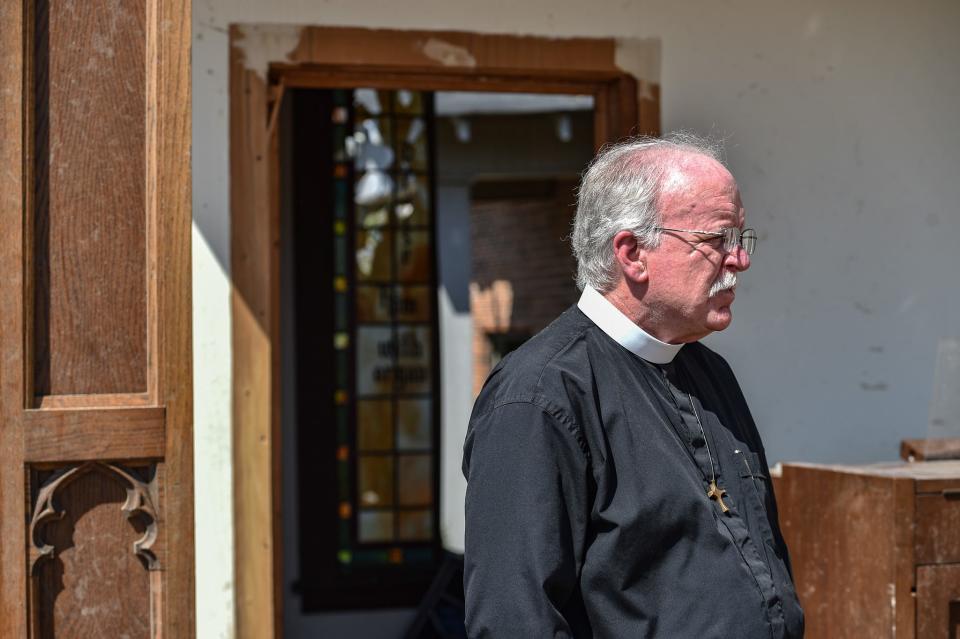 Greg Proctor, the rector of the Chapel of the Cross Episcopal Church, pauses as he begins the clean-up in Rolling Fork on Sunday.