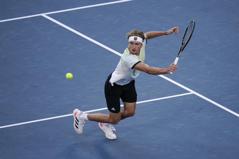 Alexander Zverev, of Germany, returns a shot to Karen Khachanov, of the Russian Olympic Committee, during the men's single gold medal match of the tennis competition at the 2020 Summer Olympics, Sunday, Aug. 1, 2021, in Tokyo, Japan. (AP Photo/Seth Wenig)