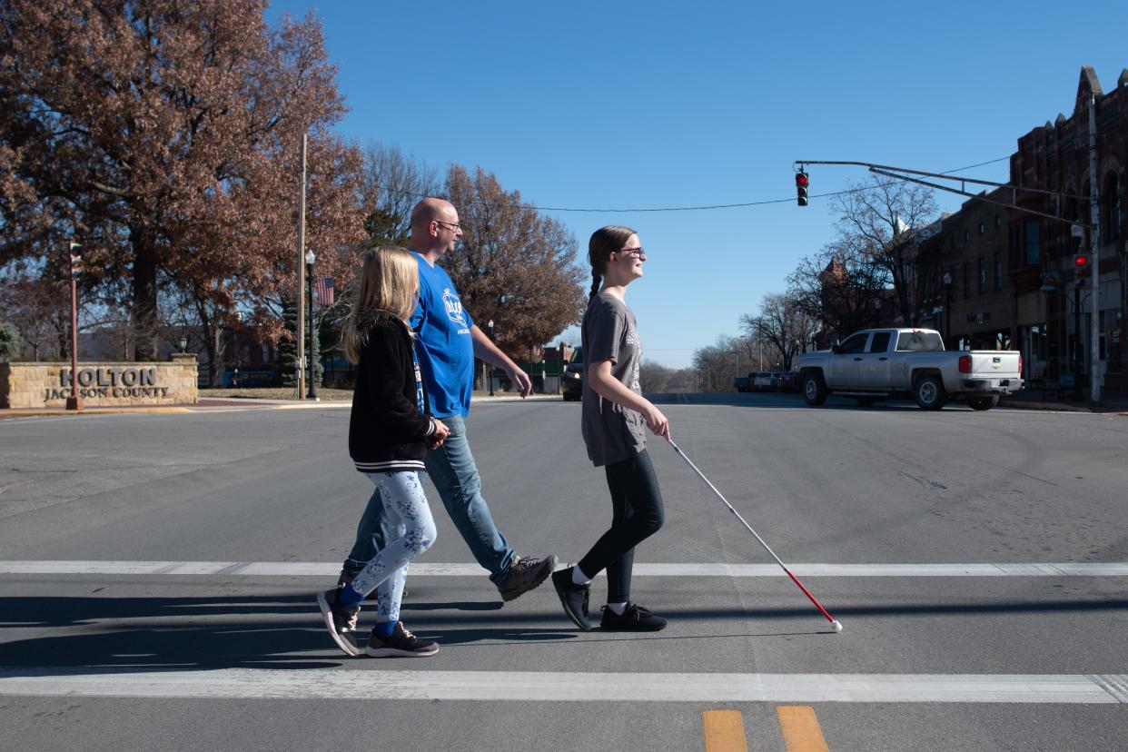 The rare visual impairment of familial exudative vitreoretinopathy, or FEVR for short, hasn't held back Addie Bartels as she leads her father Leslie and sister Amelia across W. Fourth St. in Holton.