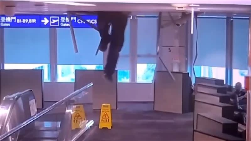 桃園機場第二航廈天花板突然爆裂，一名工人懸掛半空，嚇壞旅客。(圖/翻攝畫面)