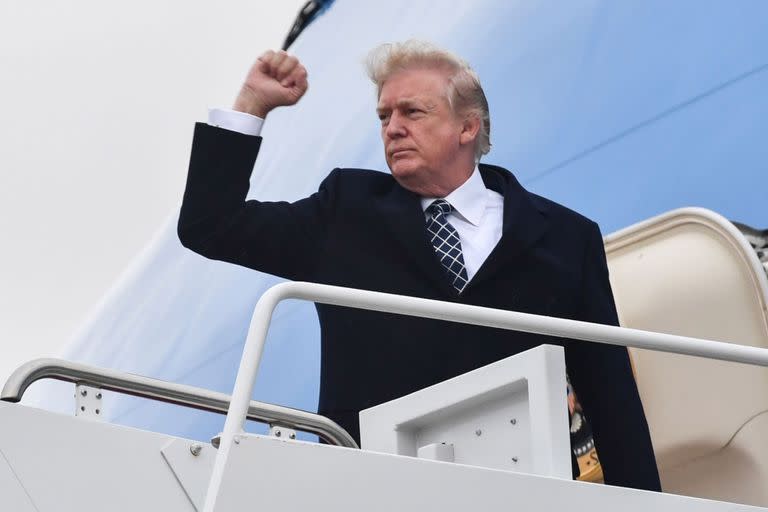 US President Donald Trump gestures as he boards Airforce One at Joint Base Andrews, Maryland on January 12, 2018, for a weekend trip to Mar-a-Lago.