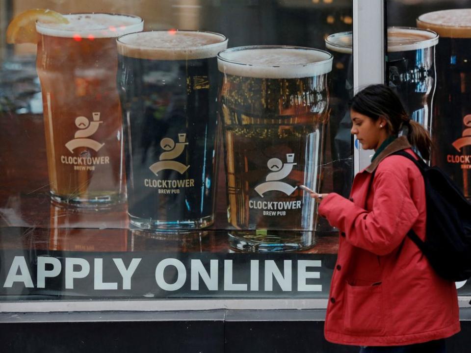 FILE PHOTO: A sign advertising available jobs at the Clocktower Brew Pub hangs in a window in Ottawa