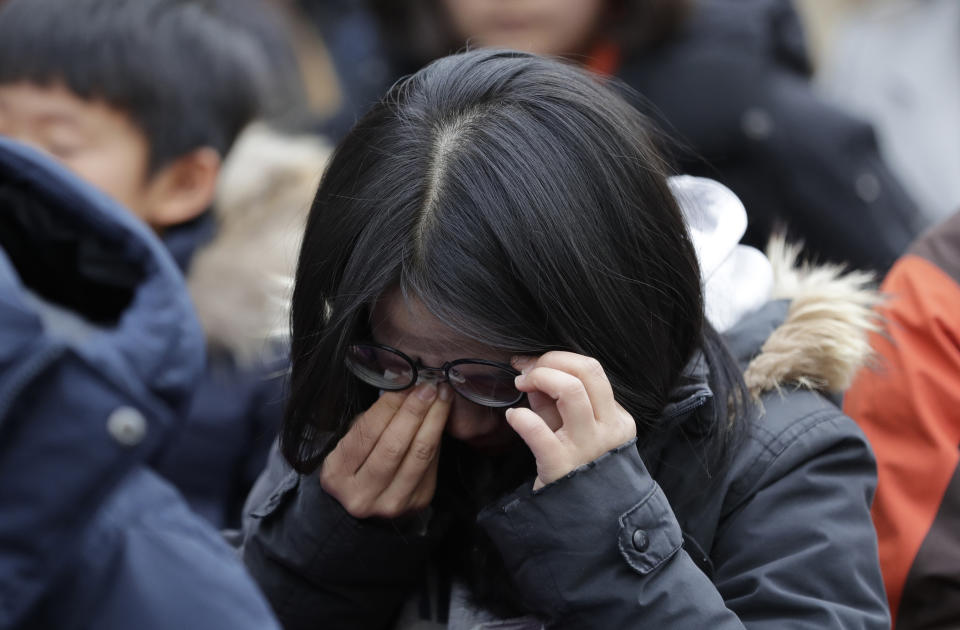 A participant wipes away tears during a weekly rally near the Japanese Embassy in Seoul, South Korea, Wednesday, Jan. 30, 2019. Hundreds of South Koreans are mourning the death of a former sex slave for the Japanese military during World War II by demanding reparations from Tokyo over wartime atrocities. (AP Photo/Lee Jin-man)