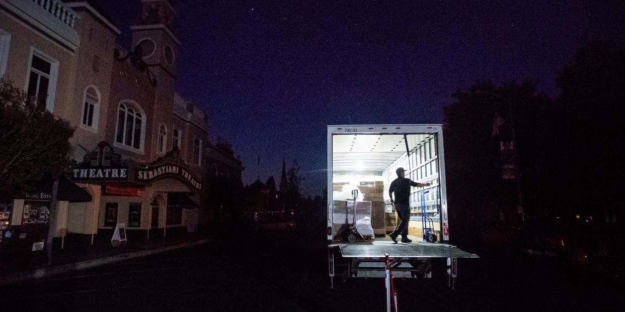 Armando Espinoza delivers paper products to a cafe in downtown Sonoma, Calif., where power is turned off, on Wednesday, Oct. 9, 2019.