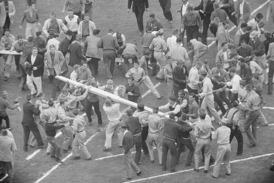 FILE - Tasting their first football victory against Oklahoma since 1951, University of Texas made quick work of tearing down the goalposts in the Cotton Bowl in Dallas, after the Longhorns dramatic 15-14 win in a college football game on Oct. 11, 1958. The Big 12 is losing its marquee matchup when the Red River Rivalry is played Saturday for the final time under the league’s umbrella. (AP Photo/Carl E. Linde, File)