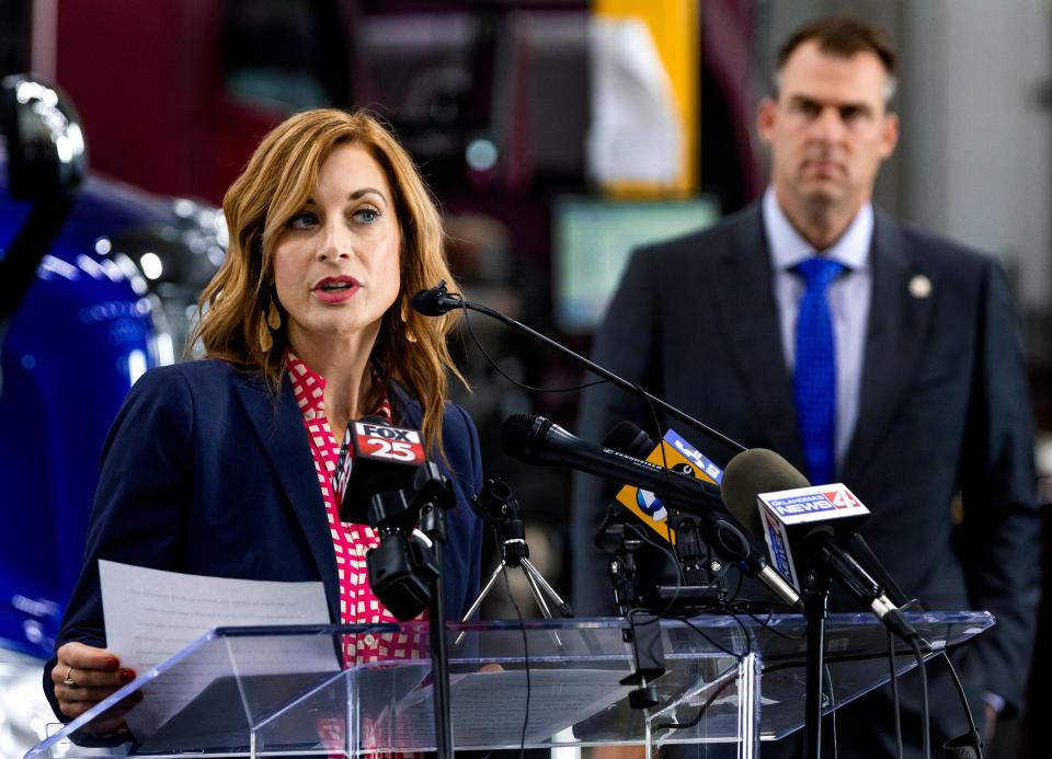 Gov. Kevin Stitt looks on as Employment Security Commission Executive Director Shelley Zumwalt speaks during a press conference to announce at $1200 return to work incentive for unemployed Oklahomans at Freymiller Trucking in Oklahoma City, Okla. on Monday, May 17, 2021.  