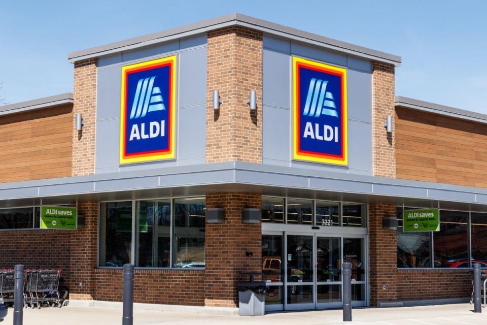 Outside of Aldi supermarket with sign and trolleys