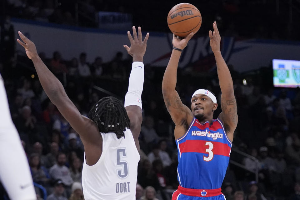 Washington Wizards guard Bradley Beal (3) shoots over Oklahoma City Thunder forward Luguentz Dort (5) in the first half of an NBA basketball game Friday, Nov. 26, 2021, in Oklahoma City. (AP Photo/Sue Ogrocki)