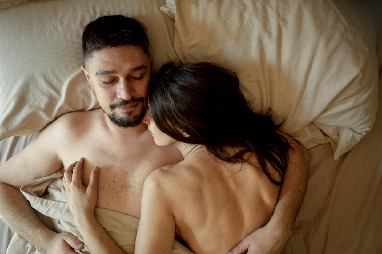 Couple in bed to illustrate an article on advice for being a better lover. 