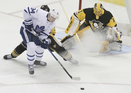 Dec 9, 2017; Pittsburgh, PA, USA; Toronto Maple Leafs center Auston Matthews (34) tries to get a shot off against Pittsburgh Penguins defenseman Olli Maatta (3) and goalie Casey DeSmith (1) during the second period at PPG PAINTS Arena. Mandatory Credit: Don Wright-USA TODAY Sports