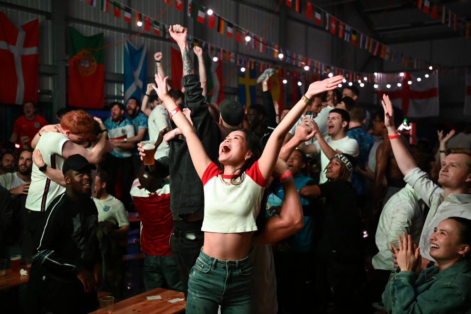 Fans celebrate an England goal at a screening in Hackney Bridge, London.