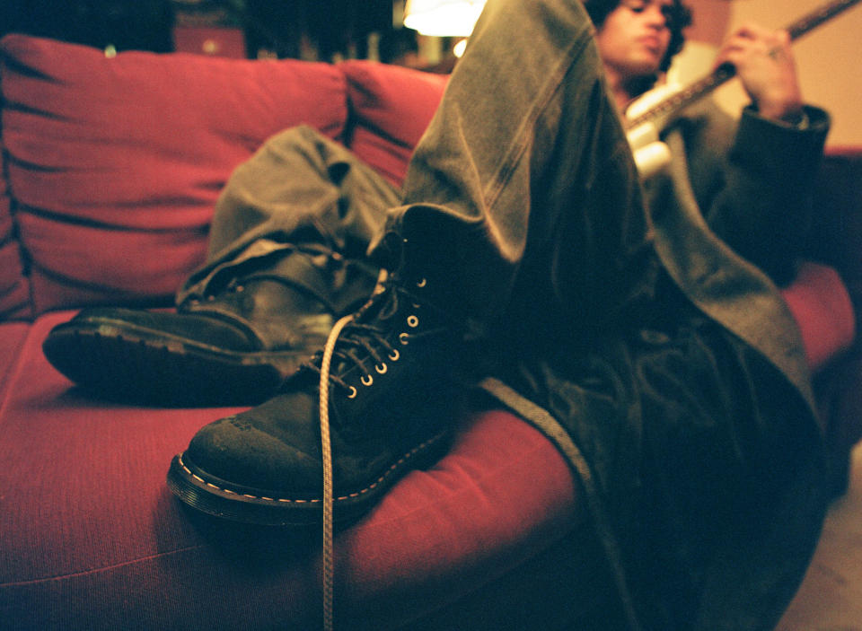 A close up of Dominic Fike wearing the Dr. Martens 1460 boot.