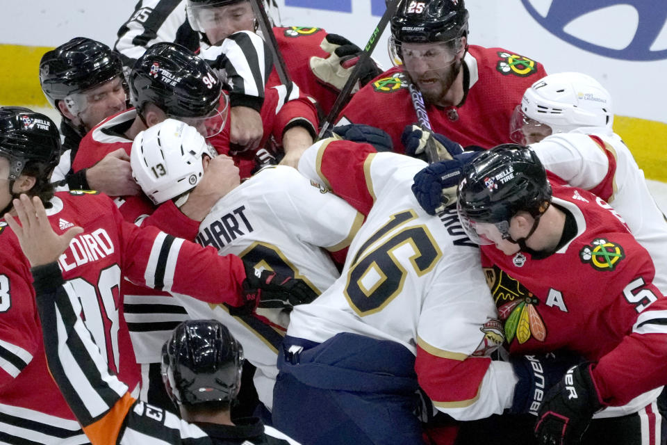 The Florida Panthers and Chicago Blackhawks mix it up in front of the Blackhawks' goal during the first period of an NHL hockey game Saturday, Nov. 4, 2023, in Chicago. (AP Photo/Charles Rex Arbogast)