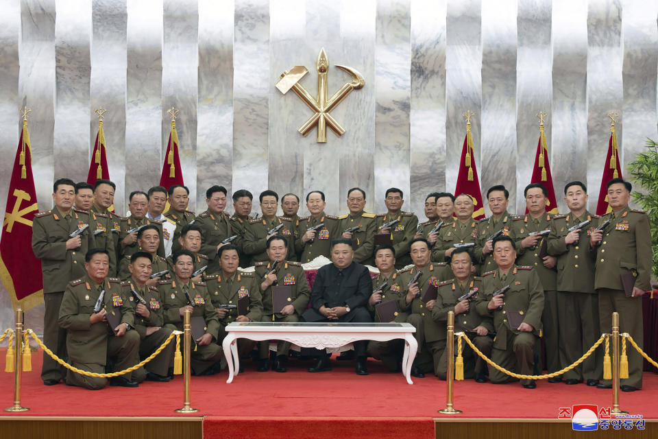 In this Sunday, July 26, 2020, photo released by the North Korean government, North Korean leader Kim Jong Un, center, poses for a photo with senior military officials holding “Paektusan” commemorative pistols they received from Kim during a ceremony in Pyongyang, North Korea. Independent journalists were not given access to cover the event depicted in this image distributed by the North Korean government. The content of this image is as provided and cannot be independently verified. Korean language watermark on image as provided by source reads: "KCNA" which is the abbreviation for Korean Central News Agency. (Korean Central News Agency/Korea News Service via AP)