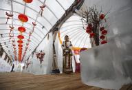 A waitress poses during a photo opportunity at the Ice Palace in Shangri-La Hotel in the northern city of Harbin, Heilongjiang province January 6, 2014. The Ice Palace, which is built by ice bricks, is open annually from December to February and attracts visitors during the Harbin Ice and Snow Festival. The temperatures inside the ice building is maintained around -10 degrees Celsius and it consists of bar and hot pot restaurant. REUTERS/Kim Kyung-Hoon (CHINA - Tags: SOCIETY TRAVEL ENVIRONMENT)