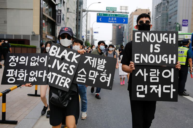 People march on the street in solidarity with protests against the death in Minneapolis police custody of George Floyd in Seoul