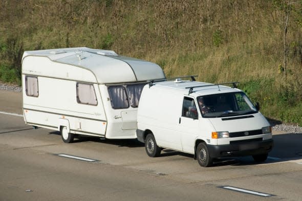 ACYMNR M25 motorway white van towing white caravan both clean unmarked with obscured number plate