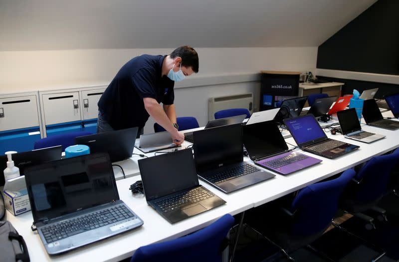 FILE PHOTO: Donated laptops are processed and made safe before being passed onto schools so children can use them for home learning