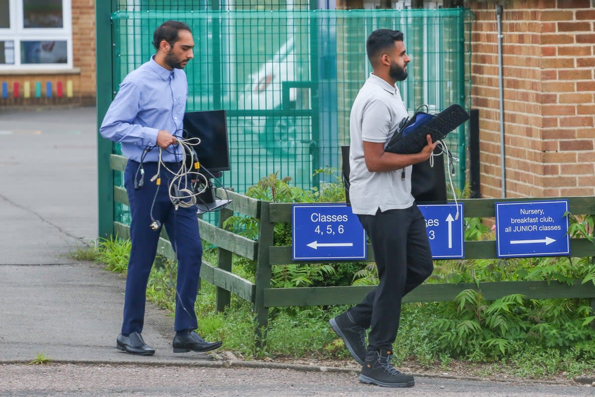 Staff at Willowbrook Mead Primary Academ, in Leicester, move equipment as they are told they must close due to the risk of RAAC in its buildings (Joseph Walshe / SWNS)