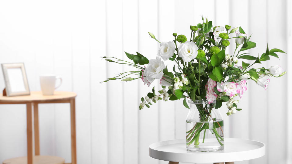 Flowers in vase on white table