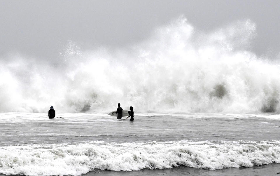 Surfers brave the waves during a rain storm at Venice Beach in Los Angeles on Saturday, Jan. 14, 2023. (Keith Birmingham/The Orange County Register via AP)