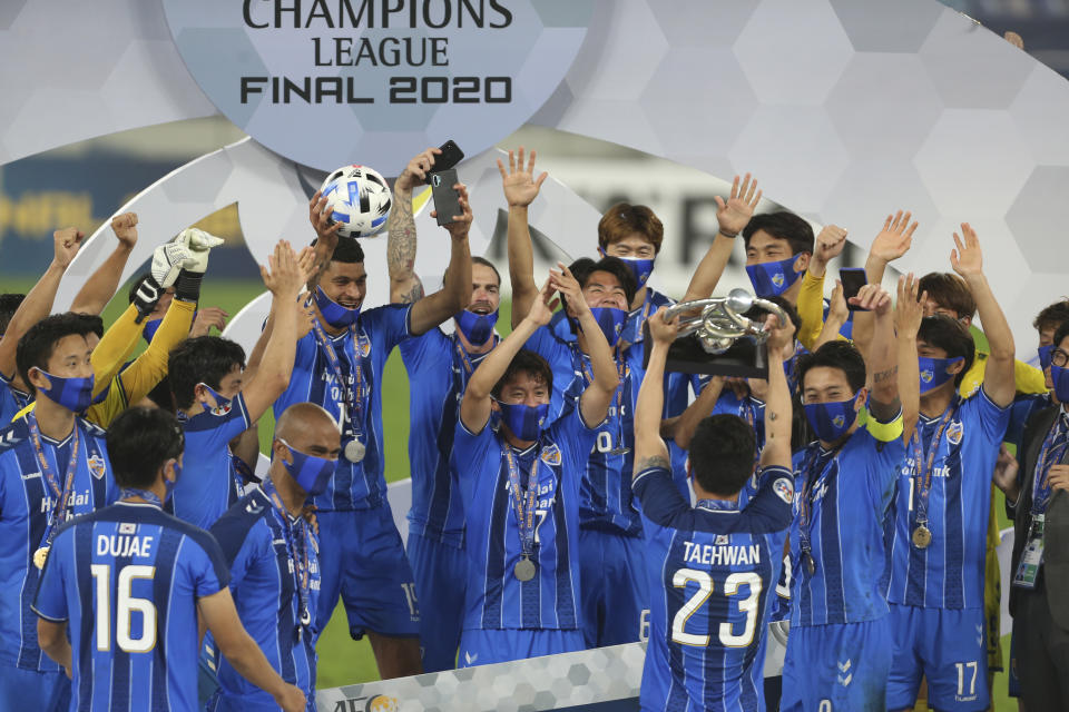 FILE - In this Dec. 19, 2020, file photo, Ulsan Hyundai's players celebrate with their trophy after the AFC Champions League final match against Persepolis in Al Wakrah, Qatar. The Asian Champions League's eastern zone competition will finally kick off after a series of delays and withdrawals. But the troubled tournament has a different look to previous editions of the continental club championship. (AP Photo/Hussein Sayed,File)